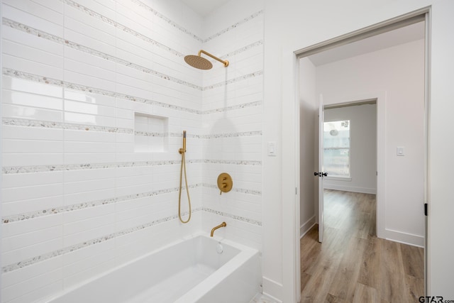 bathroom with wood-type flooring and tiled shower / bath combo