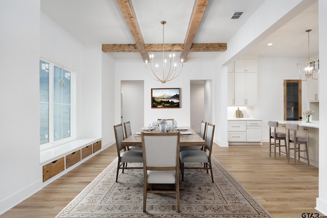 dining room with beamed ceiling, a chandelier, and light wood-type flooring