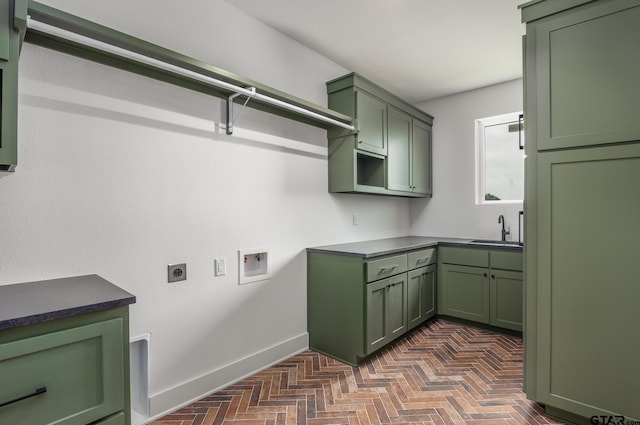 clothes washing area featuring hookup for an electric dryer, dark parquet floors, hookup for a washing machine, cabinets, and sink