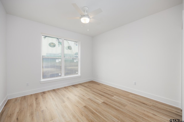 spare room featuring light wood-type flooring and ceiling fan