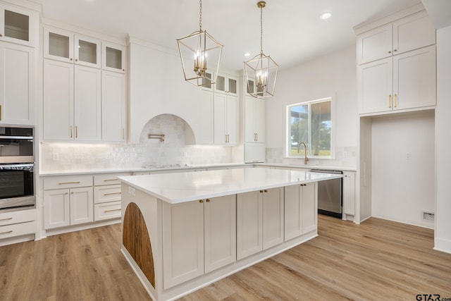 kitchen with white cabinetry, appliances with stainless steel finishes, and a center island