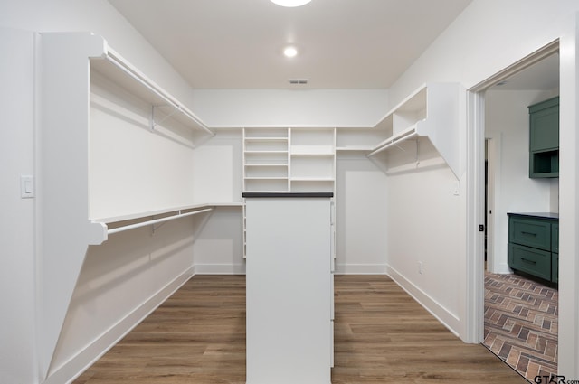 spacious closet featuring light hardwood / wood-style floors