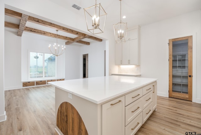 kitchen with light hardwood / wood-style floors, pendant lighting, and a kitchen island