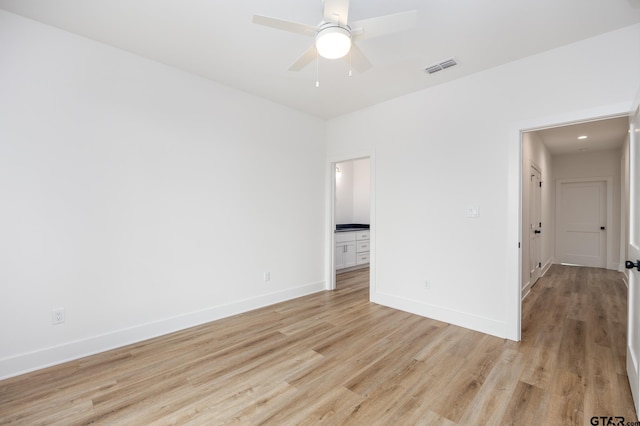 unfurnished room with light wood-type flooring and ceiling fan