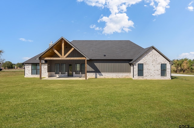 back of property featuring a lawn and a patio area