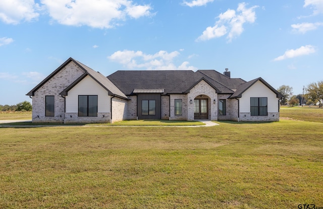 french country style house with a front lawn