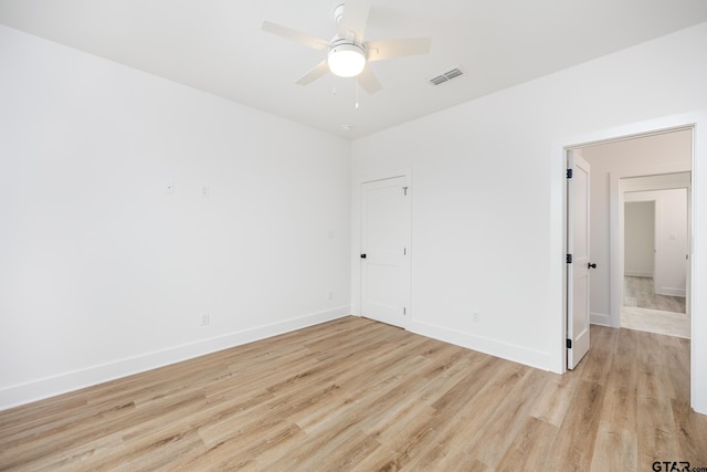 unfurnished room with light wood-type flooring and ceiling fan