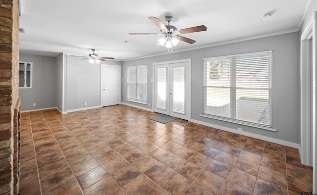 spare room with a ceiling fan, french doors, crown molding, and baseboards