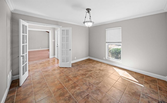 spare room with baseboards, dark tile patterned flooring, crown molding, and french doors