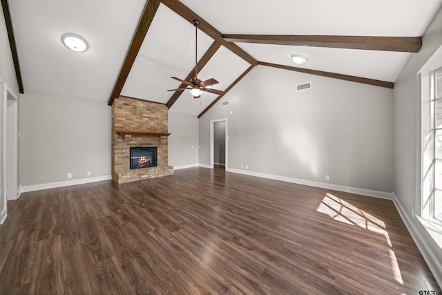 unfurnished living room with dark wood-type flooring, beamed ceiling, a brick fireplace, and visible vents