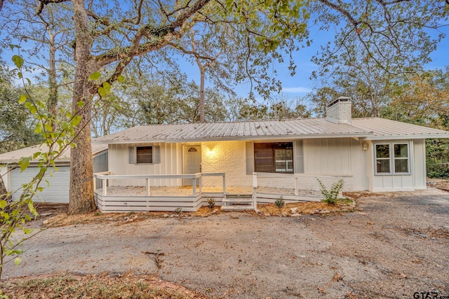 single story home featuring a garage and covered porch