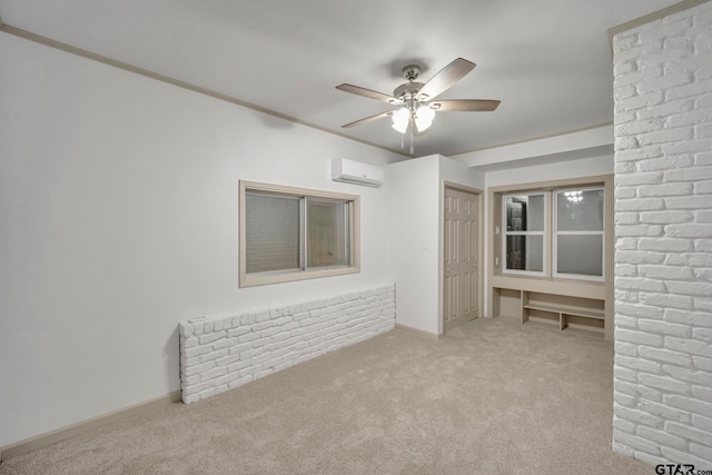 carpeted spare room with a wall mounted AC, ornamental molding, and ceiling fan