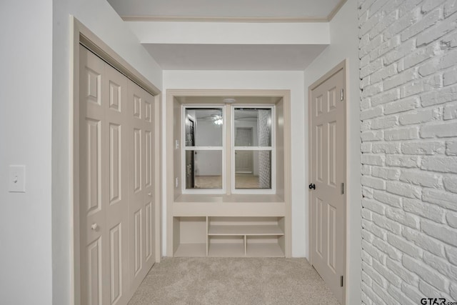 corridor with carpet flooring and crown molding