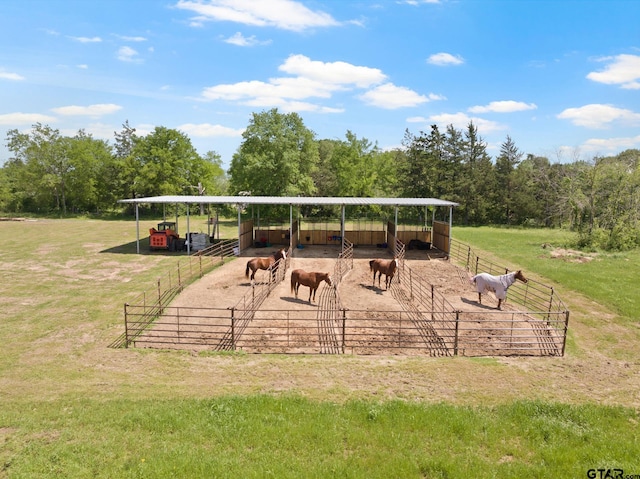view of community with an outdoor structure, an exterior structure, and a rural view
