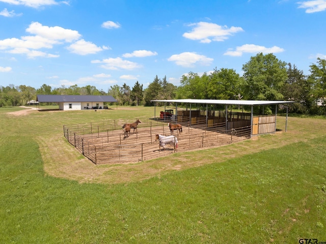 view of property's community featuring a rural view, an exterior structure, and an outdoor structure