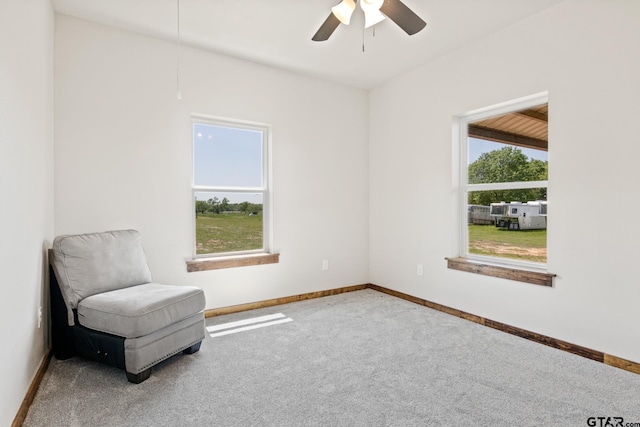 unfurnished room with carpet floors, baseboards, a ceiling fan, and attic access