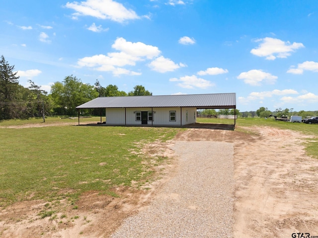 view of front facade featuring metal roof, a front lawn, and dirt driveway