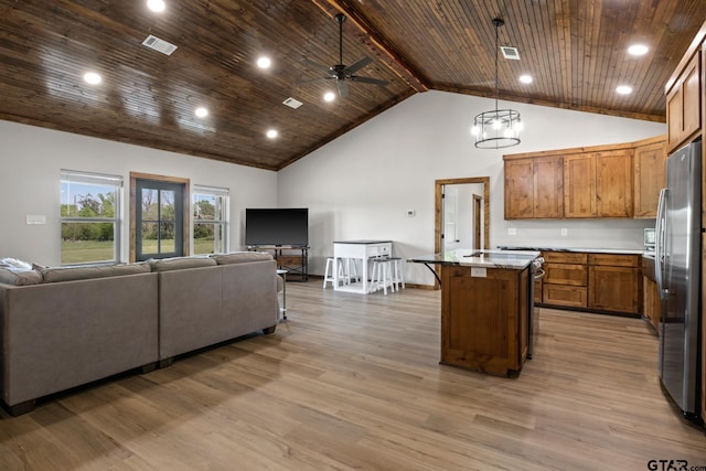 kitchen with visible vents, open floor plan, freestanding refrigerator, wood ceiling, and wood finished floors
