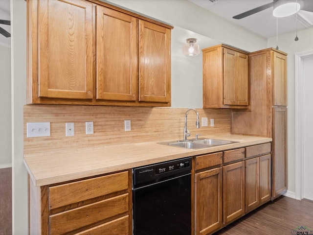 kitchen with light countertops, black dishwasher, backsplash, and a sink