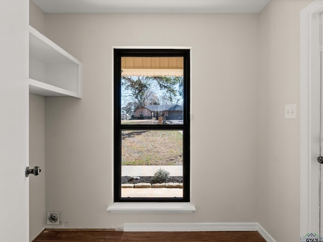 laundry area with laundry area, electric dryer hookup, and wood finished floors