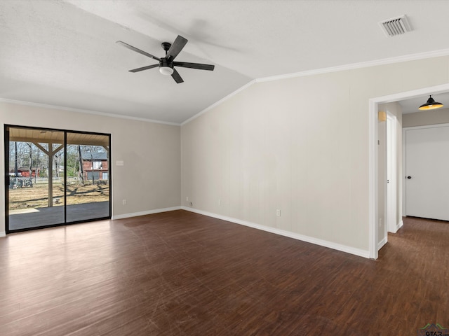 spare room featuring visible vents, vaulted ceiling, ornamental molding, wood finished floors, and a ceiling fan