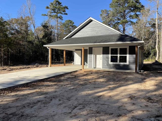 farmhouse inspired home with a carport