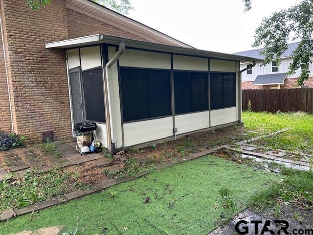 504 Mt Sylvan, Lindale, TX 75771 - view of home's exterior with a sunroom and brick siding