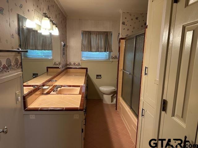 504 Mt Sylvan, Lindale, TX 75771 - bathroom featuring toilet, vanity, crown molding, wallpapered walls, and combined bath / shower with glass door