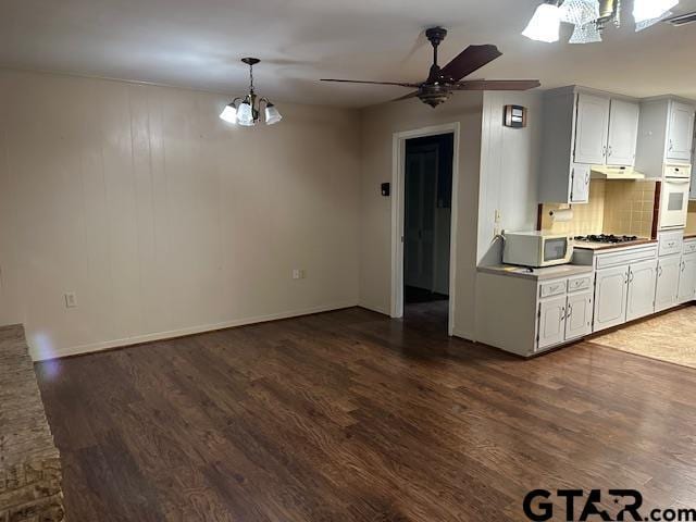 504 Mt Sylvan, Lindale, TX 75771 - kitchen featuring a chandelier, dark wood-type flooring, white appliances, backsplash, and a ceiling fan