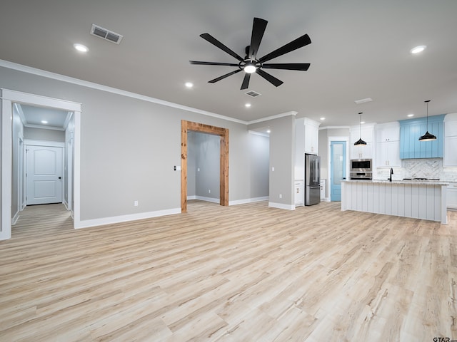 328 Heritage Way, Bullard, TX 75757 - unfurnished living room featuring ceiling fan, recessed lighting, crown molding, baseboards, and a sink