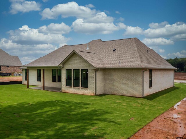 328 Heritage Way, Bullard, TX 75757 - back of house featuring brick siding, roof with shingles, a yard, and a patio area