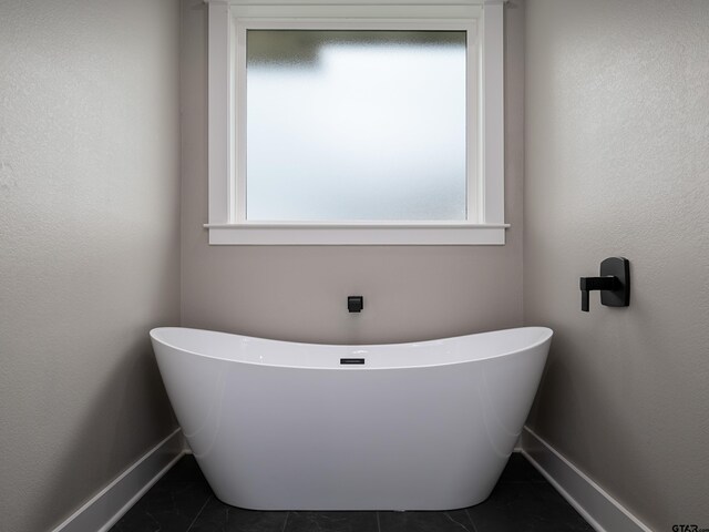 328 Heritage Way, Bullard, TX 75757 - full bath featuring a freestanding bath, baseboards, and tile patterned floors