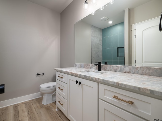 328 Heritage Way, Bullard, TX 75757 - full bathroom with vanity, baseboards, toilet, wood finished floors, and tiled shower