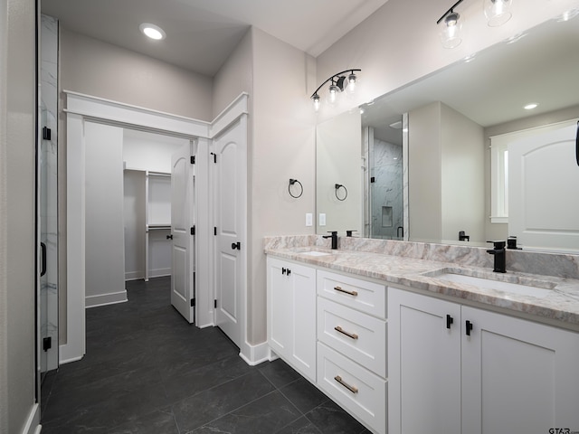 328 Heritage Way, Bullard, TX 75757 - bathroom featuring a shower stall, double vanity, a spacious closet, baseboards, and recessed lighting