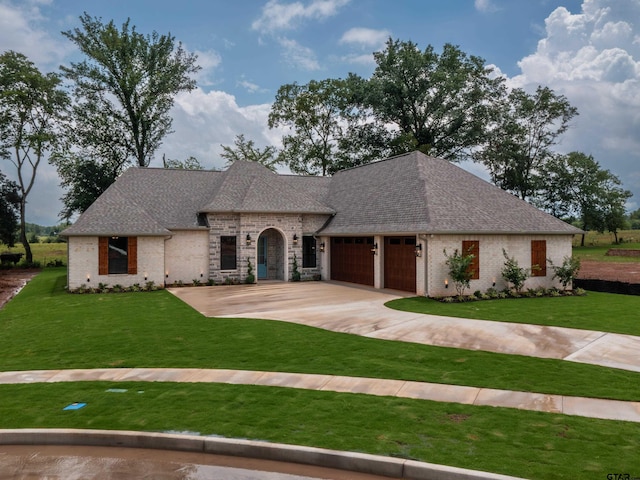328 Heritage Way, Bullard, TX 75757 - french country inspired facade featuring a front lawn, an attached garage, brick siding, and roof with shingles