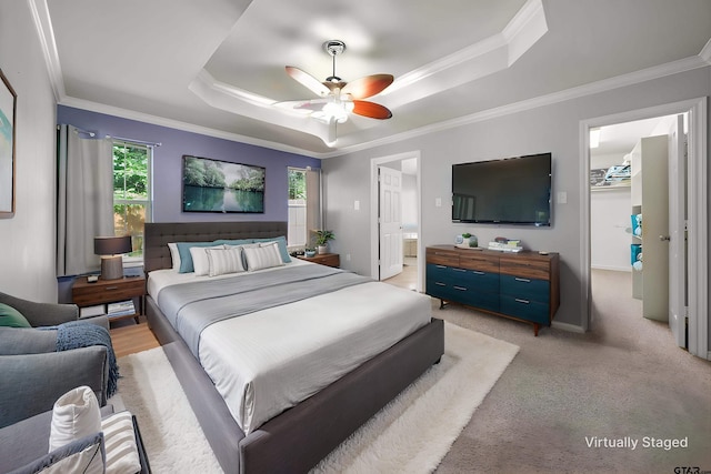 17570 Regal Row, Flint, TX 75762 - bedroom with a tray ceiling, crown molding, a spacious closet, baseboards, and a ceiling fan