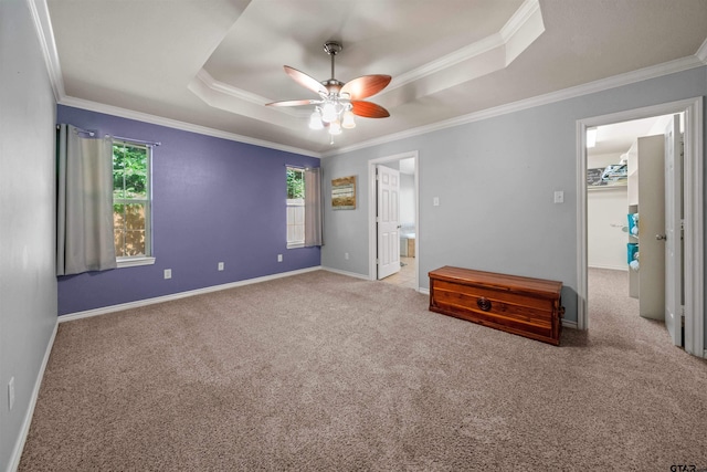 17570 Regal Row, Flint, TX 75762 - unfurnished bedroom featuring a raised ceiling, ornamental molding, carpet floors, baseboards, and a walk in closet