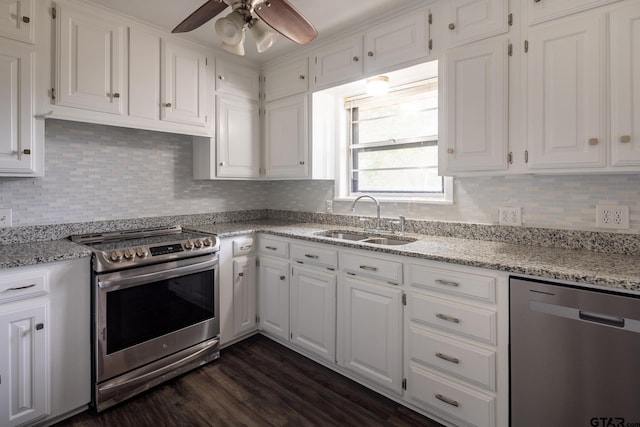 kitchen with a sink, appliances with stainless steel finishes, white cabinets, and a ceiling fan