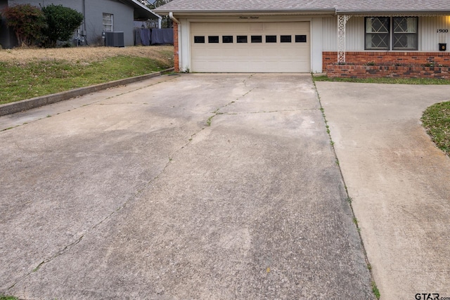 exterior space with central AC unit and concrete driveway