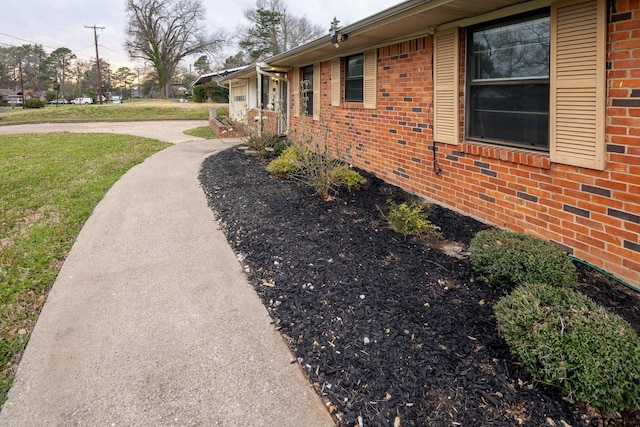 view of property exterior featuring brick siding