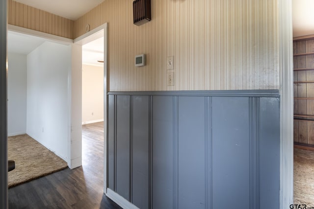 hall featuring baseboards and dark wood-style floors