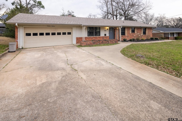 ranch-style home with roof with shingles, a front lawn, concrete driveway, a garage, and brick siding