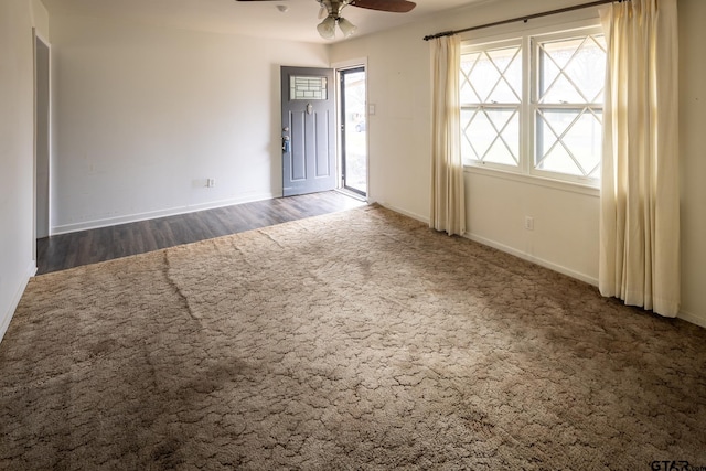 unfurnished room featuring baseboards and a ceiling fan