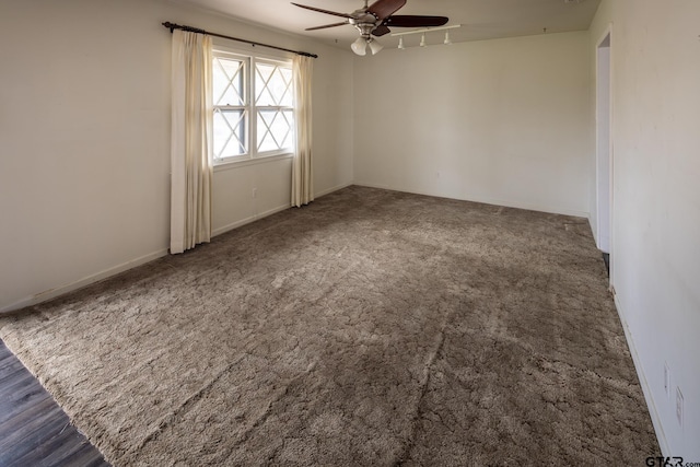 carpeted spare room with baseboards and ceiling fan