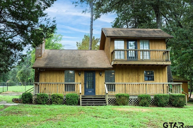 327 Dailey Rd, Crockett, TX 75835 - view of front of house featuring a chimney, a front lawn, and a balcony
