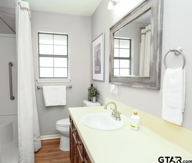 327 Dailey Rd, Crockett, TX 75835 - full bathroom with healthy amount of natural light, vanity, toilet, and wood finished floors