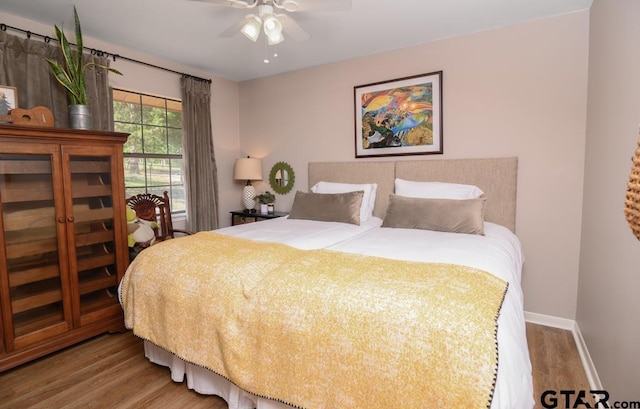 327 Dailey Rd, Crockett, TX 75835 - bedroom with wood finished floors, baseboards, and a ceiling fan