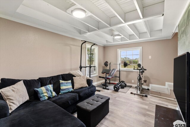 7928 Fm 127, Mount Pleasant, TX 75455 - living room featuring wood finished floors, beam ceiling, and baseboards