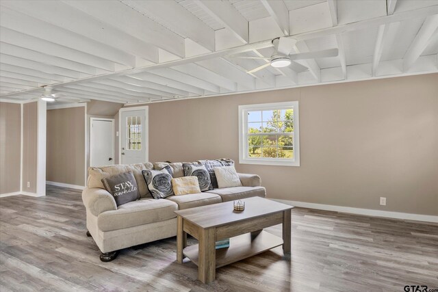 7928 Fm 127, Mount Pleasant, TX 75455 - living room with a ceiling fan, baseboards, wood finished floors, and beam ceiling