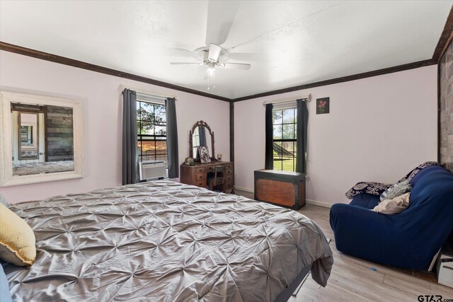 7928 Fm 127, Mount Pleasant, TX 75455 - bedroom with light wood-style flooring, multiple windows, ornamental molding, ceiling fan, and baseboards